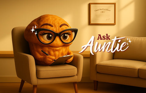 Animated character resembling a muffin with glasses sitting in a chair, holding a tablet, with 'Ask Auntie' text.