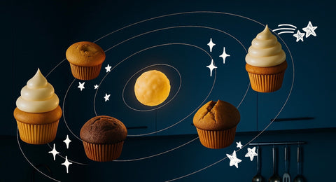 Cupcakes arranged around a moon and stars on a dark background
